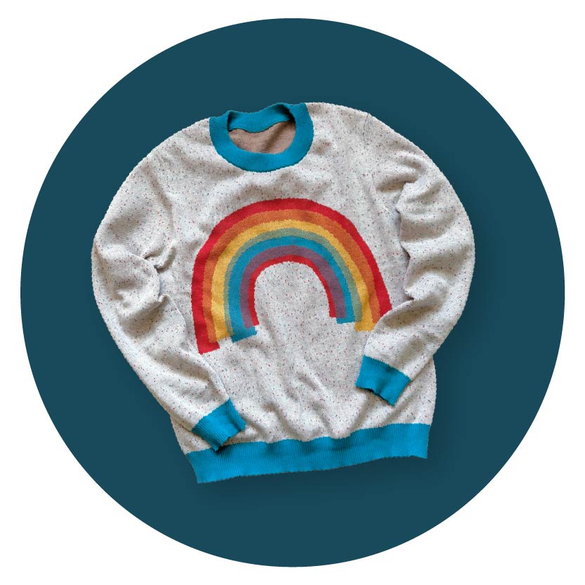Flat lay of a colorful artist graphic knit sweater with a rainbow design — shop Jedd's unique knitwear collection