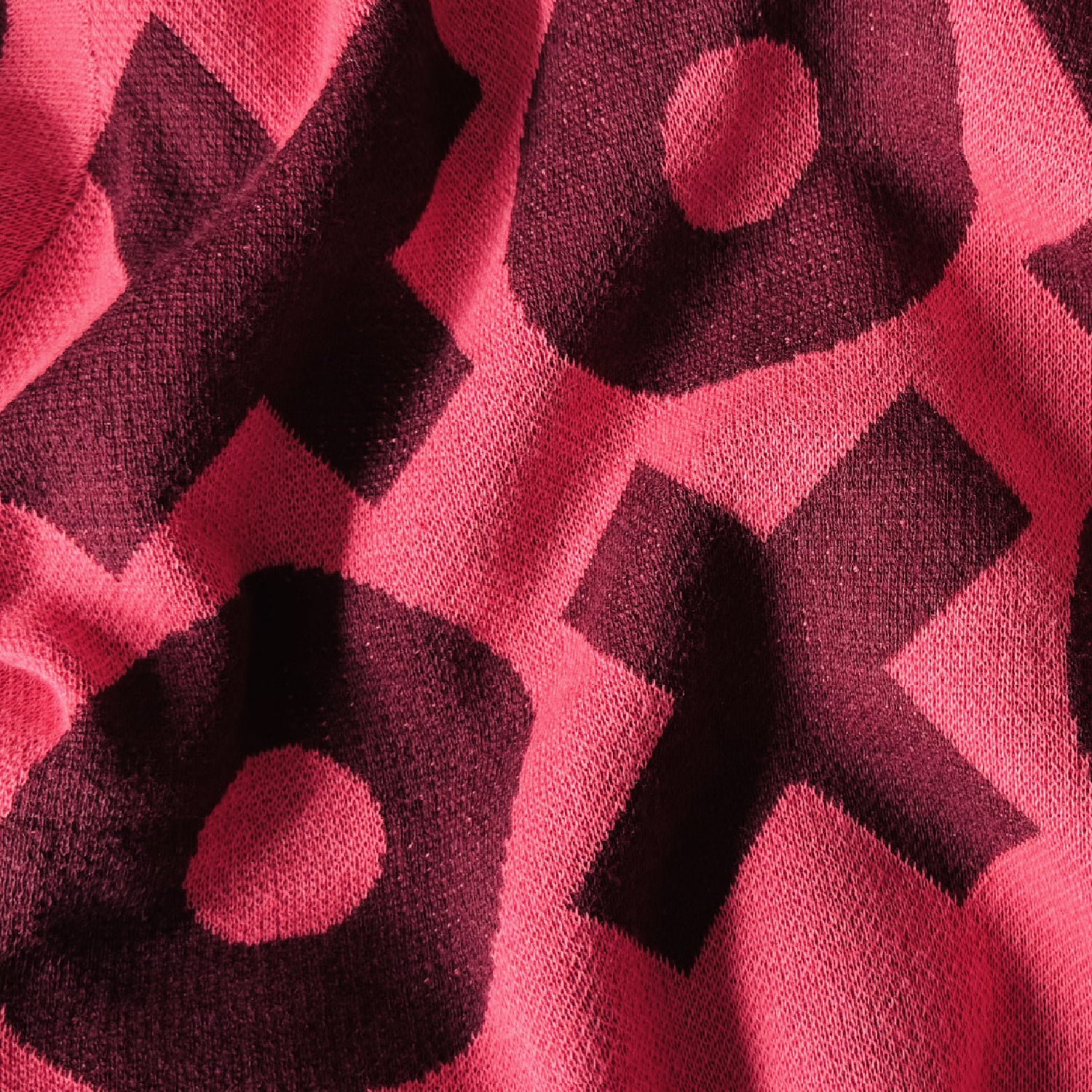 Close-up of the XOXO pattern on a pink sweater