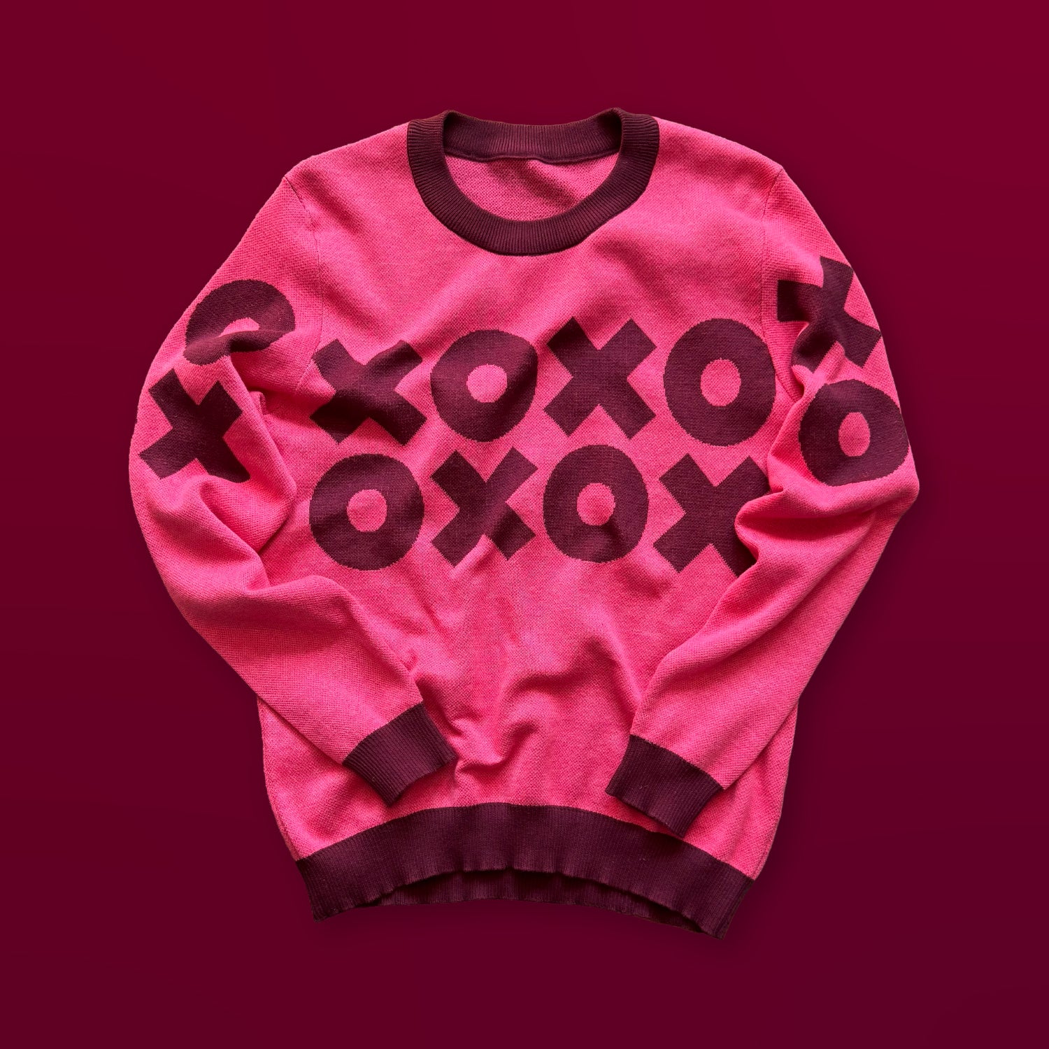 XOXO graphic knit sweater in bright pink — artist-designed hugs and kisses knitwear by Jedd, distinctive designer fashion