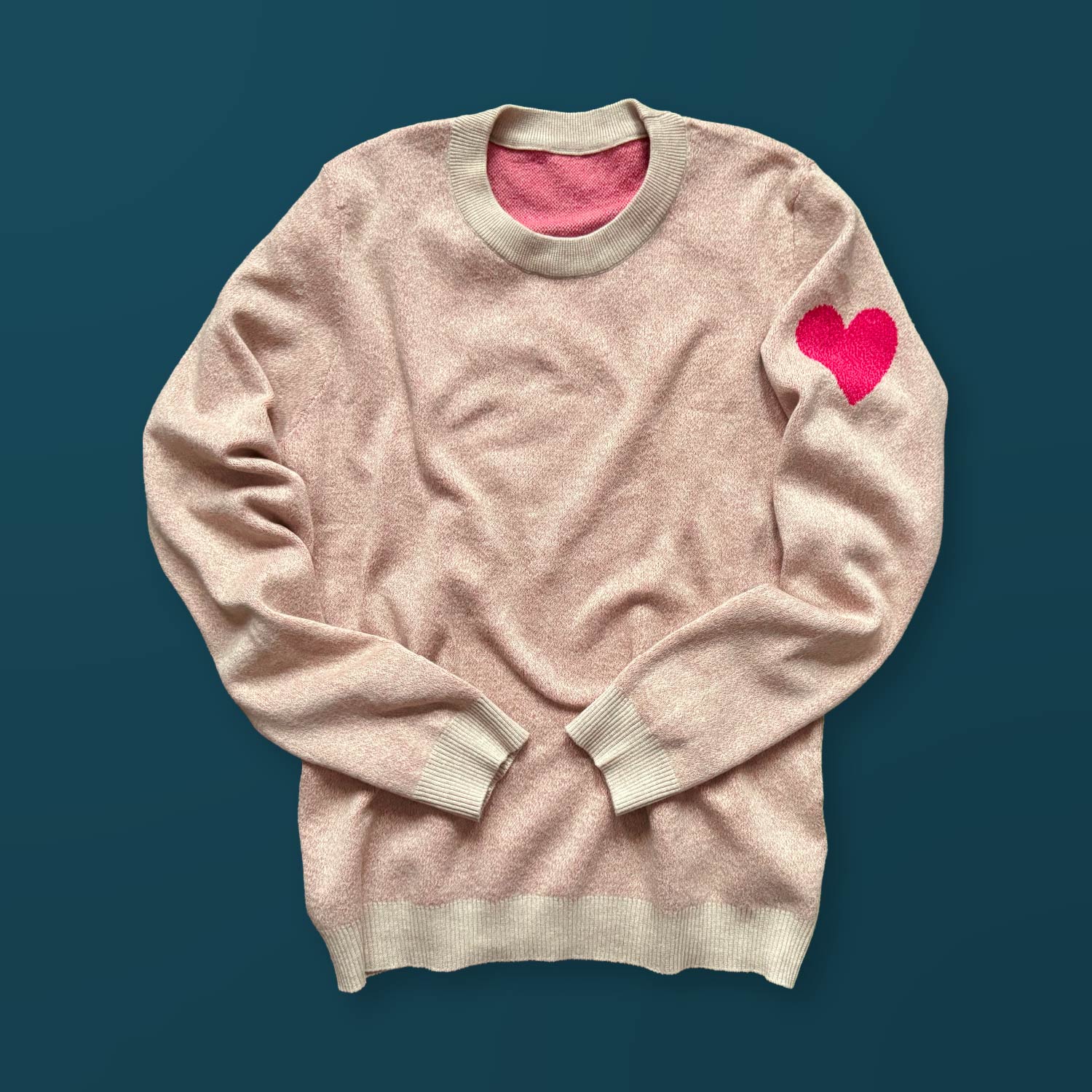 Heart On My Sleeve graphic knit sweater in heather cream — artist-designed with a bold pink heart on the left sleeve