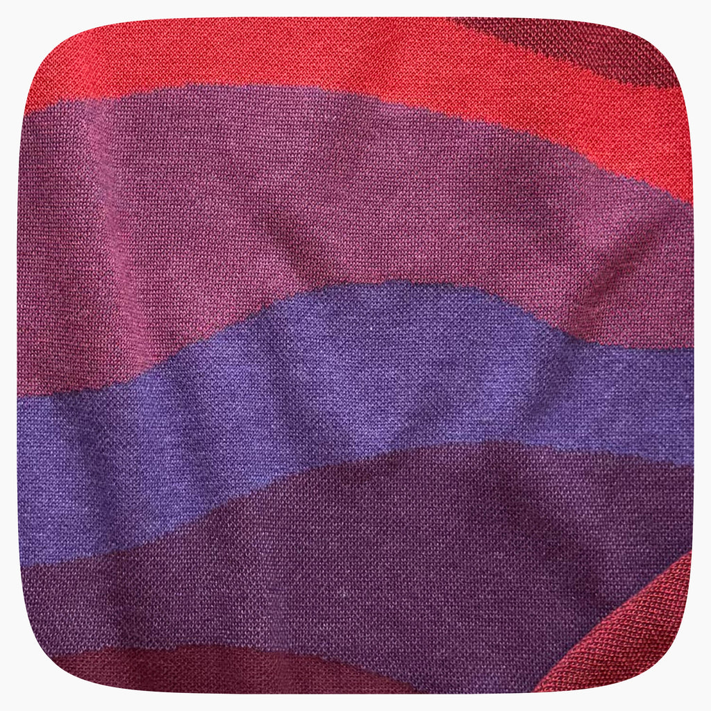 A red sweater with a patter that fades to darker red at the bottom.