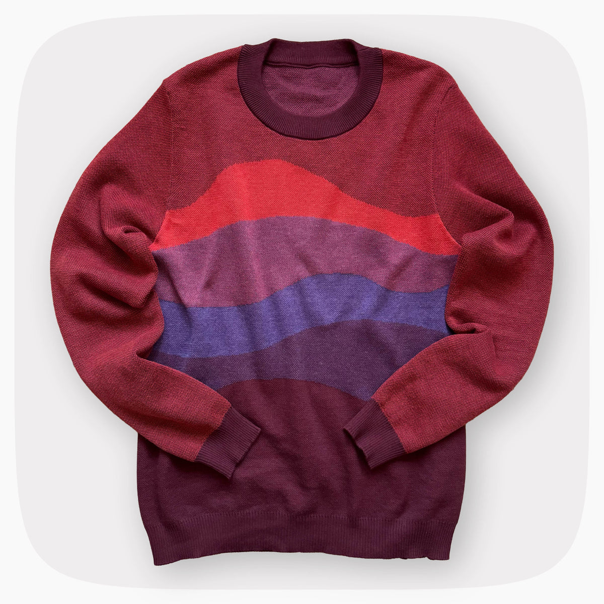 A red sweater with a patter that fades to darker red at the bottom.