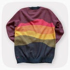 A pink sweater with a patter that fades to darker blue at the bottom.