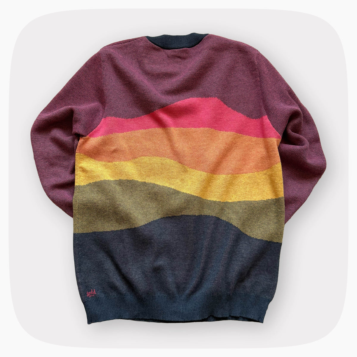 A pink sweater with a patter that fades to darker blue at the bottom.
