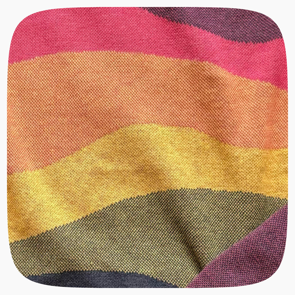 A pink sweater with a patter that fades to darker blue at the bottom.