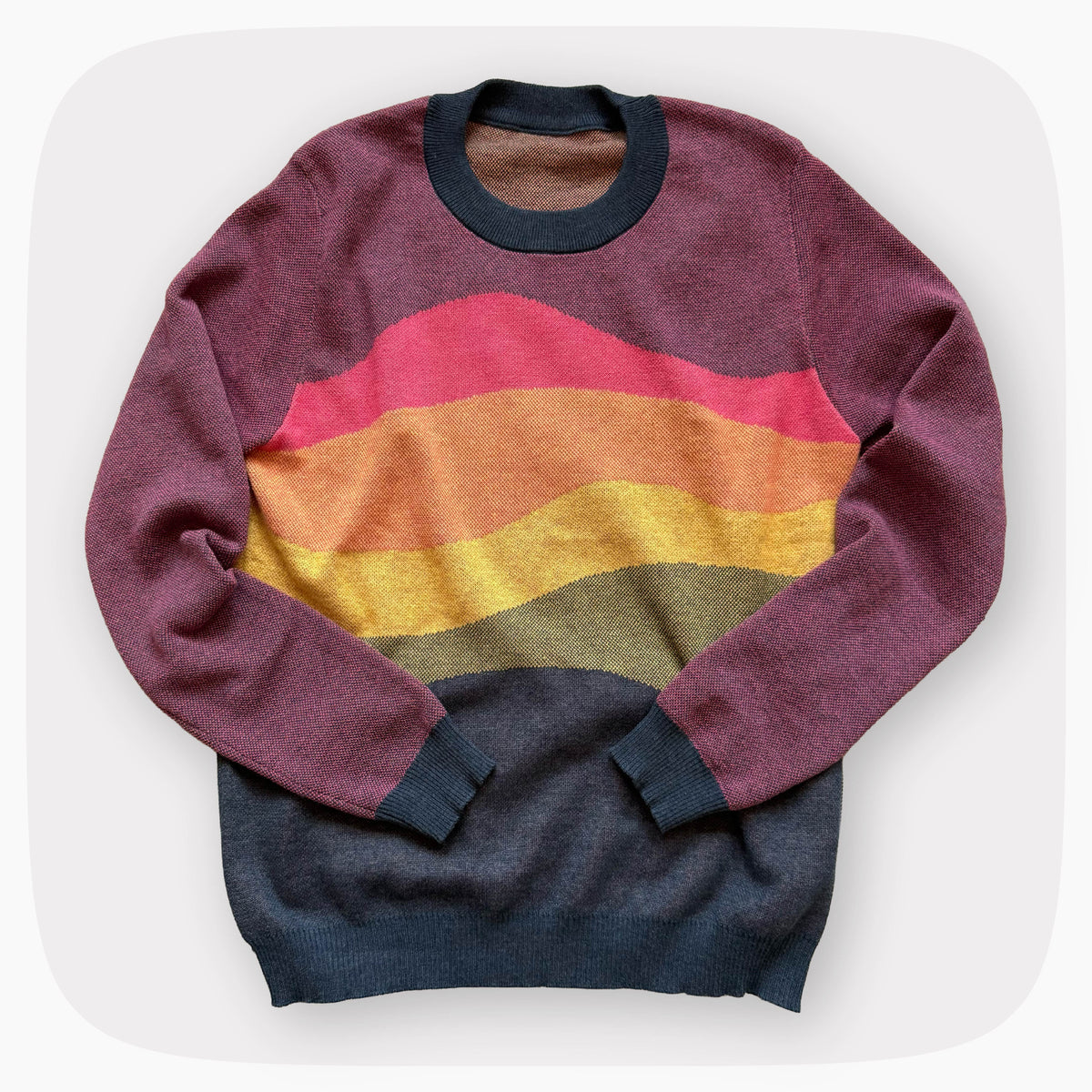 A pink sweater with a patter that fades to darker blue at the bottom.