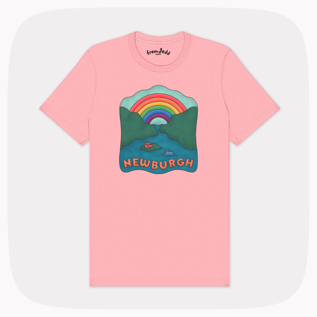 A pink t-shirt with a large illustrated design showing a river, a ferry, a castle and a rainbow that is labeled Newburgh.
