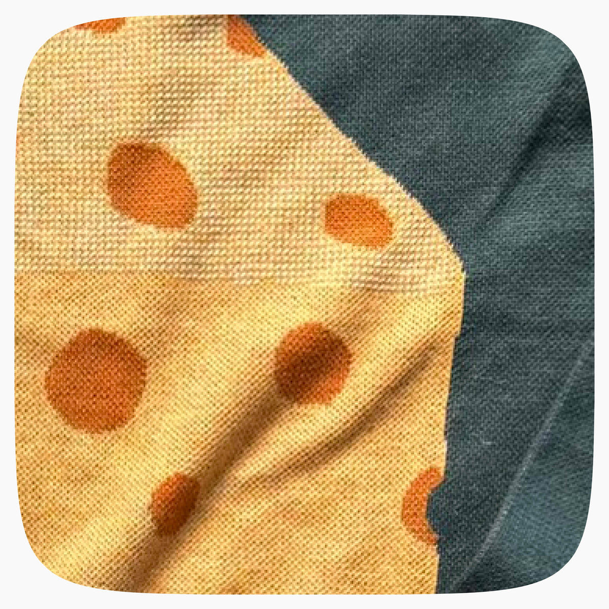 The detail of a green graphic knit sweater with a big piece of cheese design on the center.