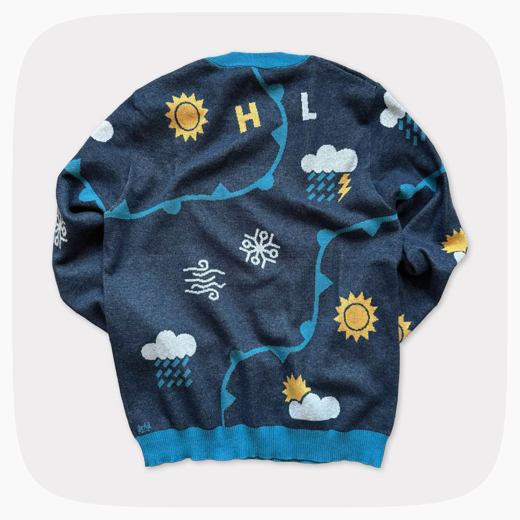 The back of a blue graphic knit sweater with weather forecast shapes like the sunny, clouds, and snowflakes.