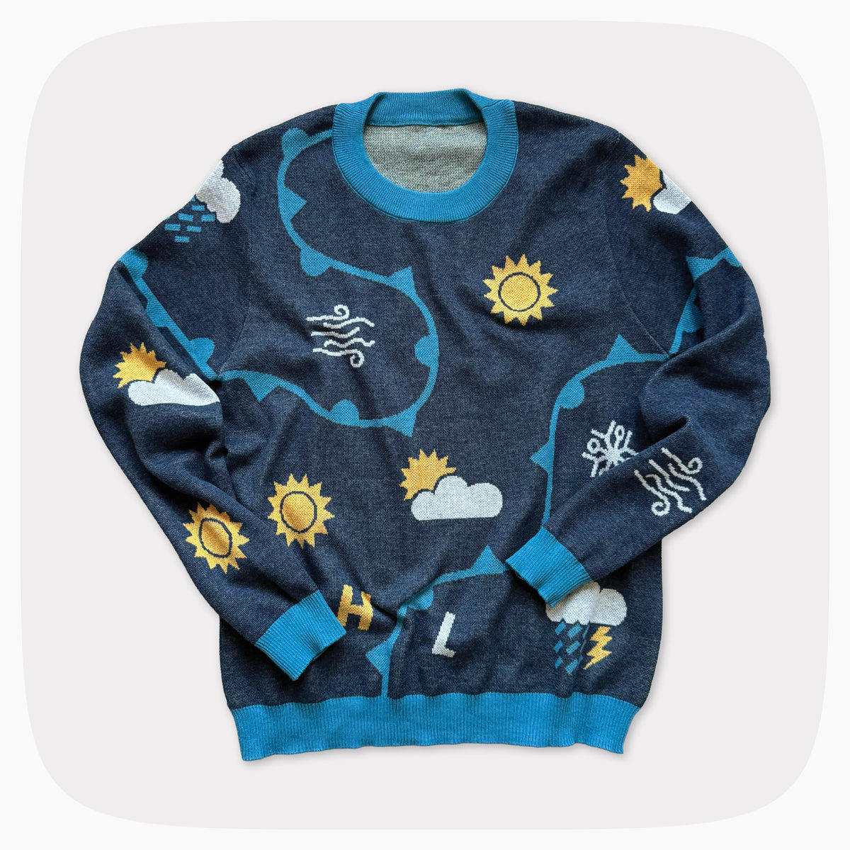 A blue graphic knit sweater with weather forecast shapes like the sunny, clouds, and snowflakes.