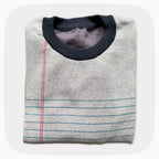 A graphic knit sweater with a pattern that looks like notebook paper.