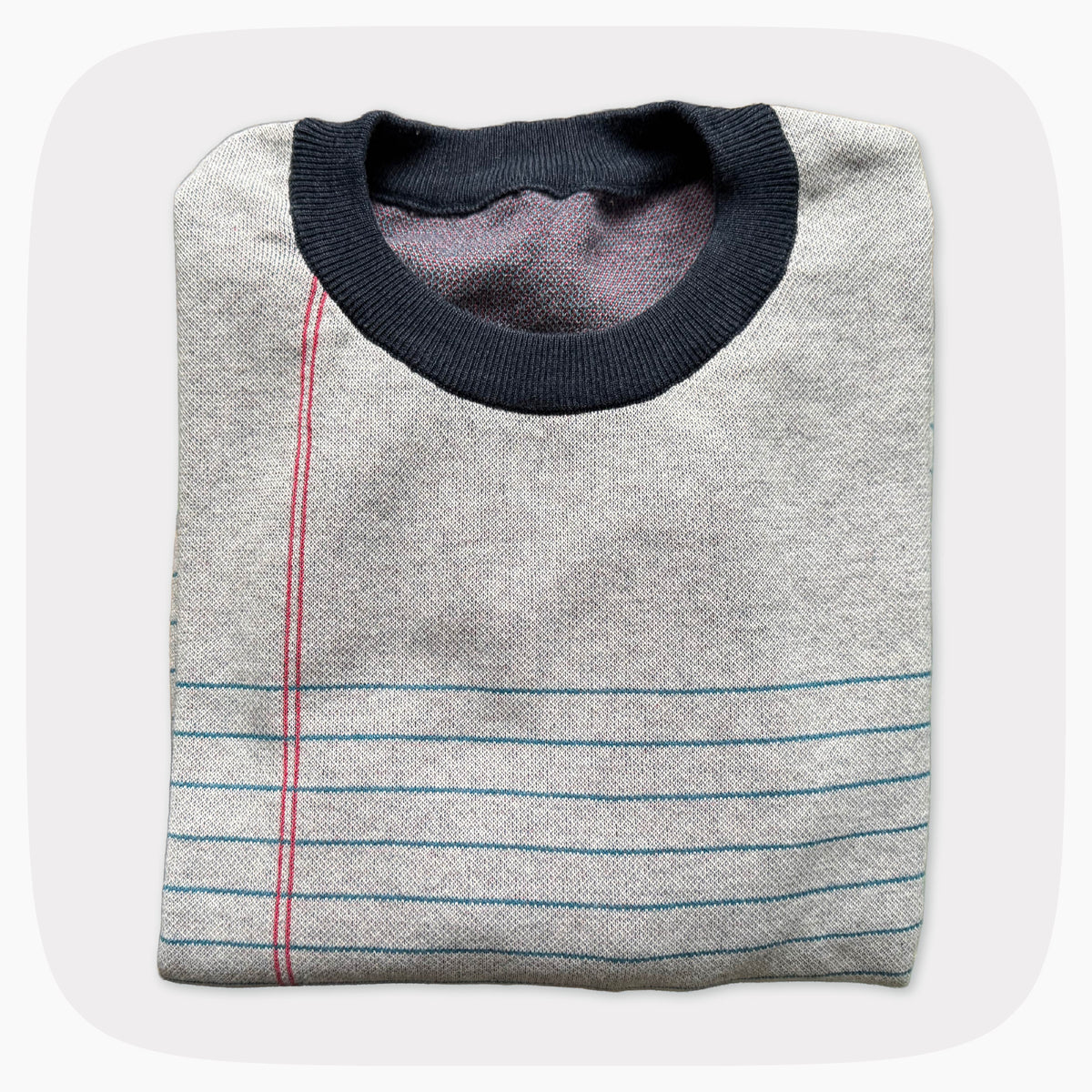 A graphic knit sweater with a pattern that looks like notebook paper.