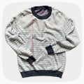 A graphic knit sweater with a pattern that looks like notebook paper.