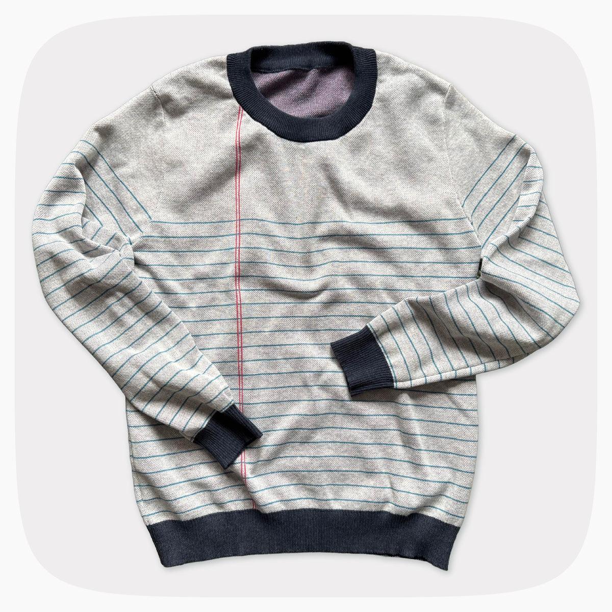 A graphic knit sweater with a pattern that looks like notebook paper.