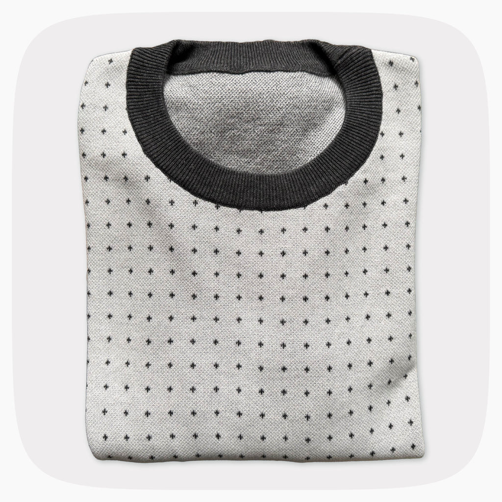 A graphic knit sweater with a pattern that looks like notebook paper.