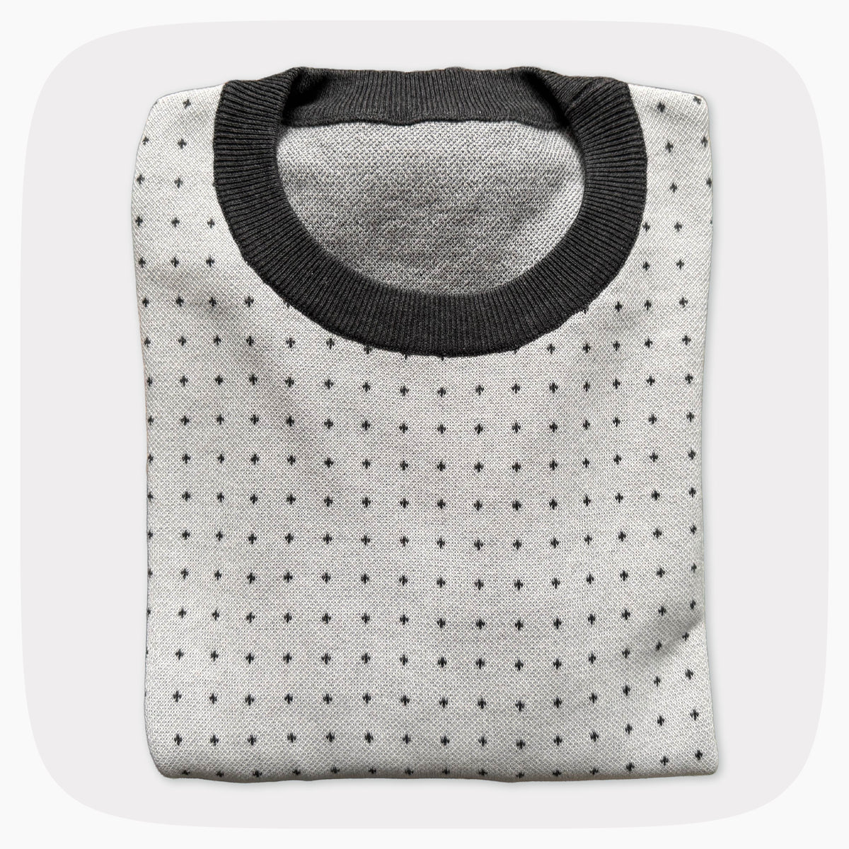 A graphic knit sweater with a pattern that looks like notebook paper.