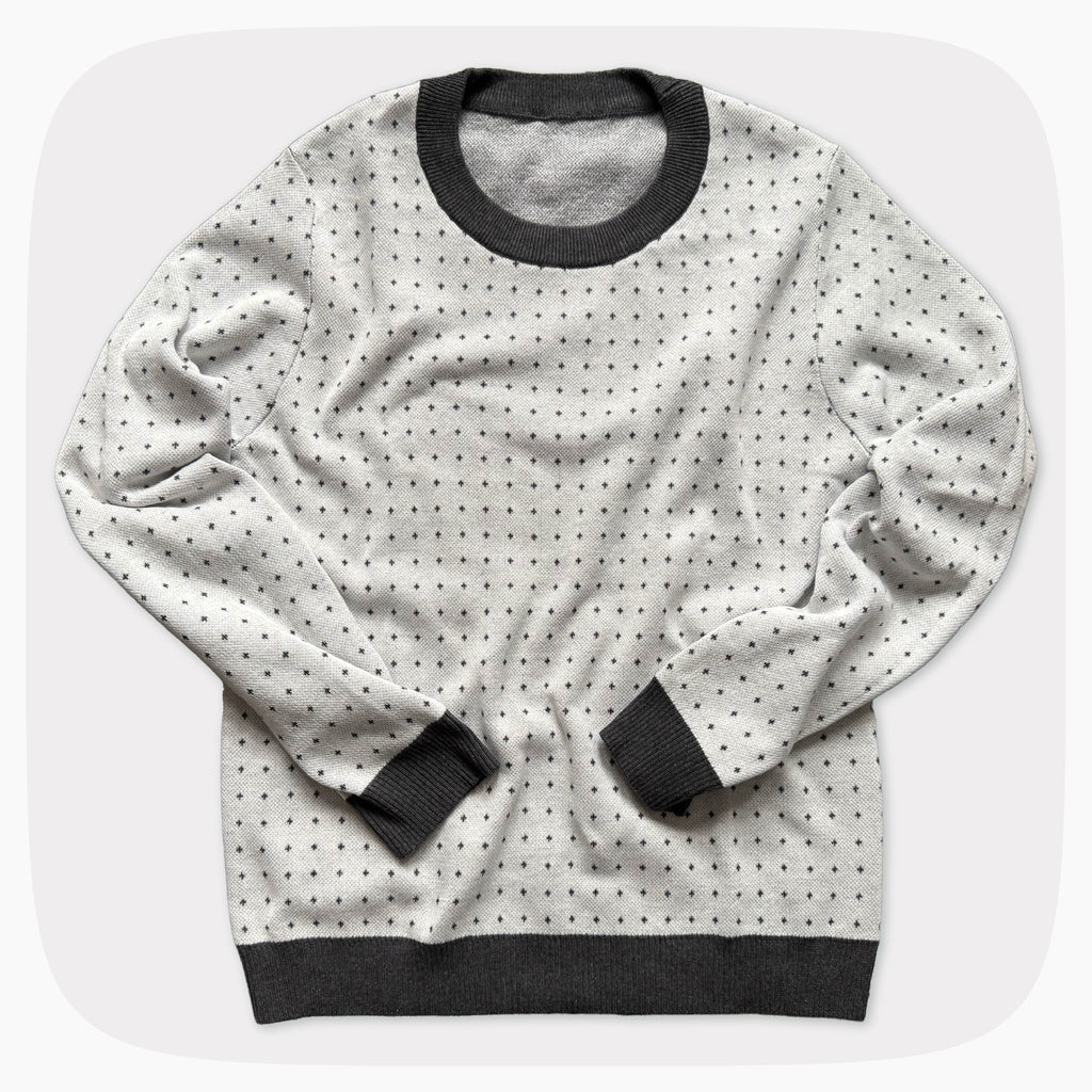 A graphic knit sweater with a pattern that looks like notebook paper.