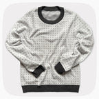 A graphic knit sweater with a pattern that looks like notebook paper.