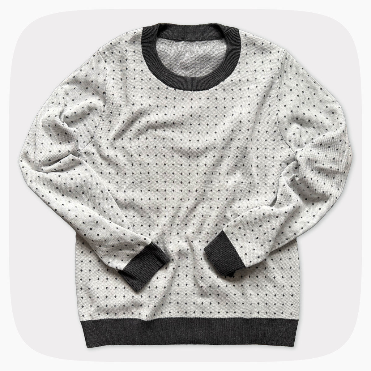 A graphic knit sweater with a pattern that looks like notebook paper.