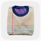 A graphic knit sweater with a pattern that looks like notebook paper.