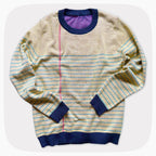 A graphic knit sweater with a pattern that looks like notebook paper.