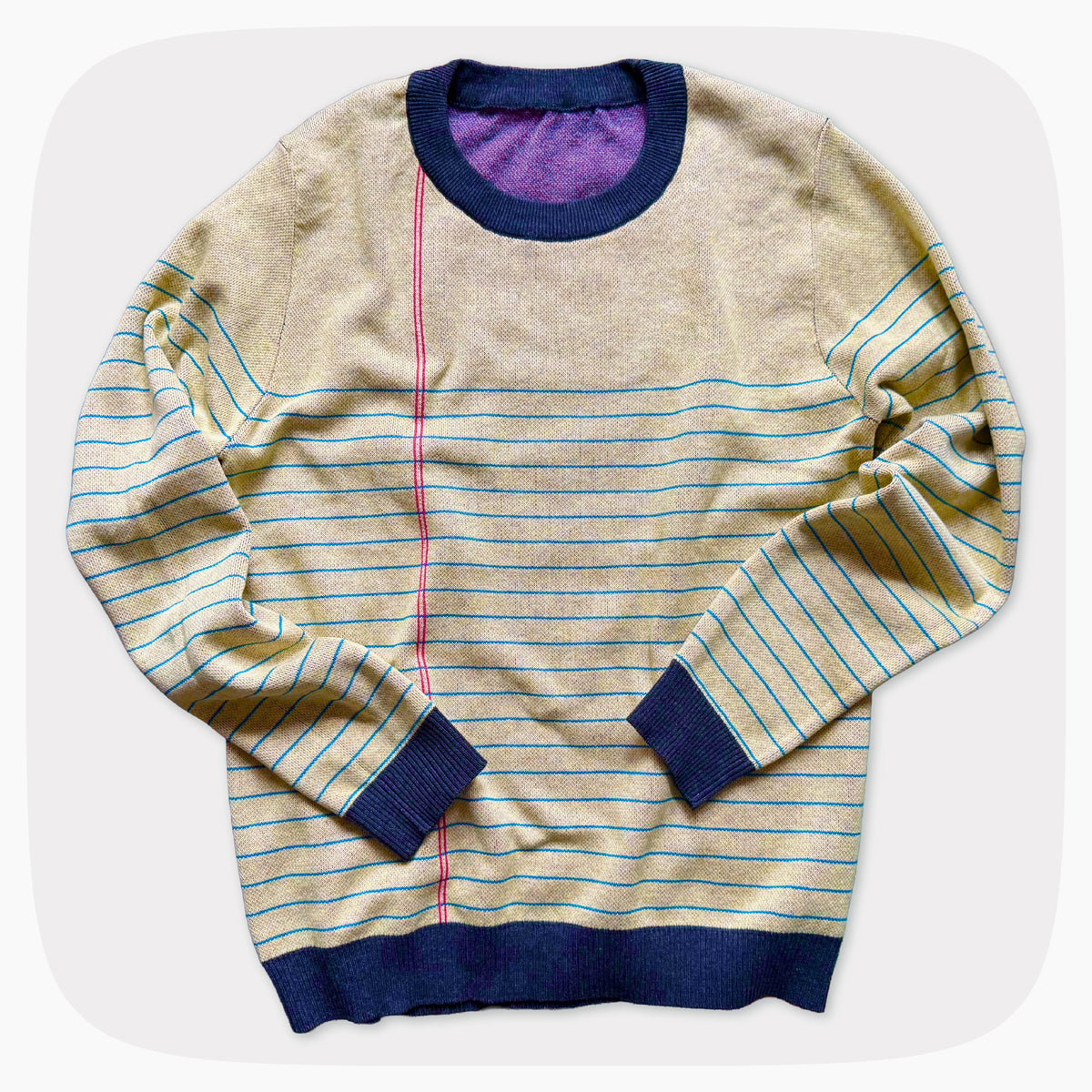 A graphic knit sweater with a pattern that looks like notebook paper.