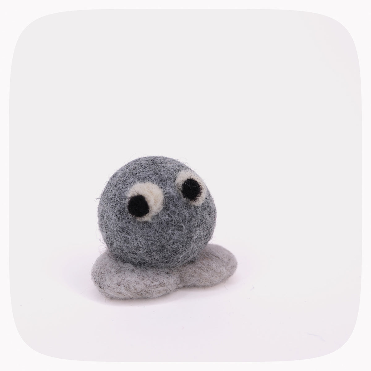 A small felted wool toy in shades of gray with black and white eyes, photographed on a clean white background with rounded corners.
