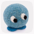 A small blue felt plush toy with a round fuzzy body, two large white-and-black embroidered eyes, and two short blue felt feet, shown on a light gray background.
