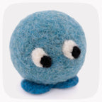 A small blue felt plush toy with a round fuzzy body, two large white-and-black embroidered eyes, and two short blue felt feet, shown on a light gray background.