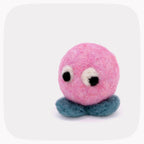 A pink felt toy with large white and black eyes and a blue-green feet, centered on a light gray background with rounded corners.