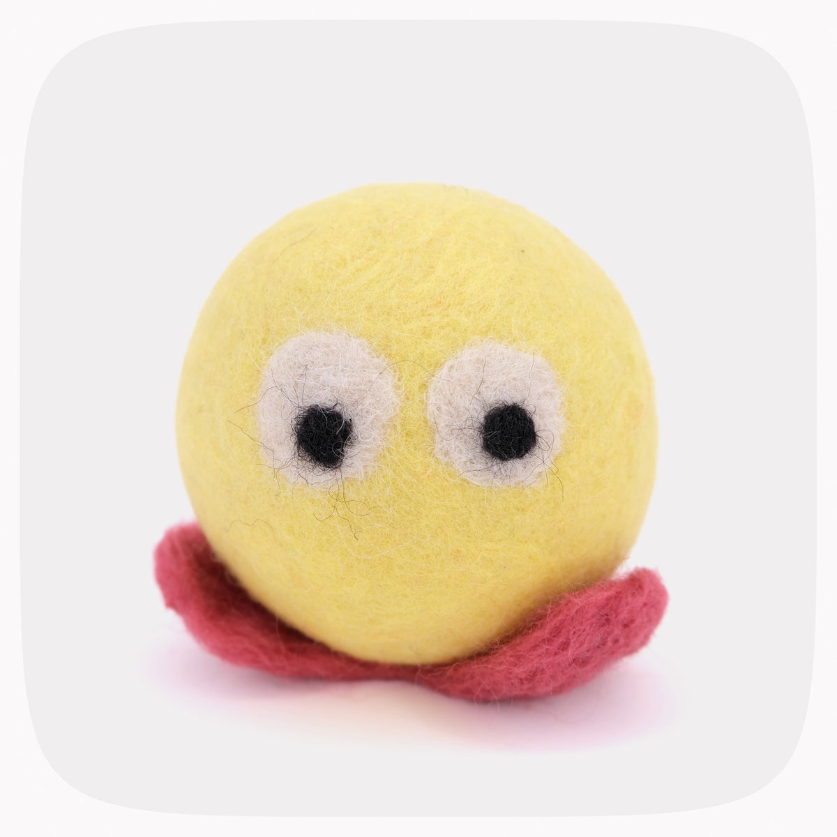 A yellow felt ball character toy with large white and black eyes and a pink felt mouth, centered on a light gray rounded-square background.