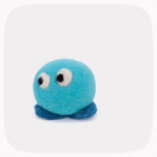 A small felt toy in bright turquoise blue with dark blue feet, white and black eyes, and white felt cheeks, photographed on a light gray background with rounded corners.