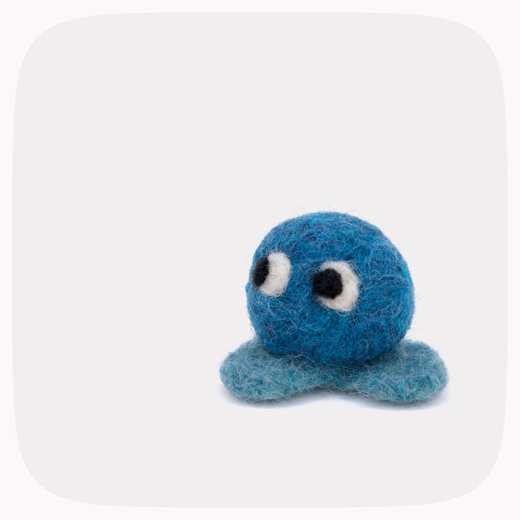 A small blue felted ball with eyes and light blue feet.