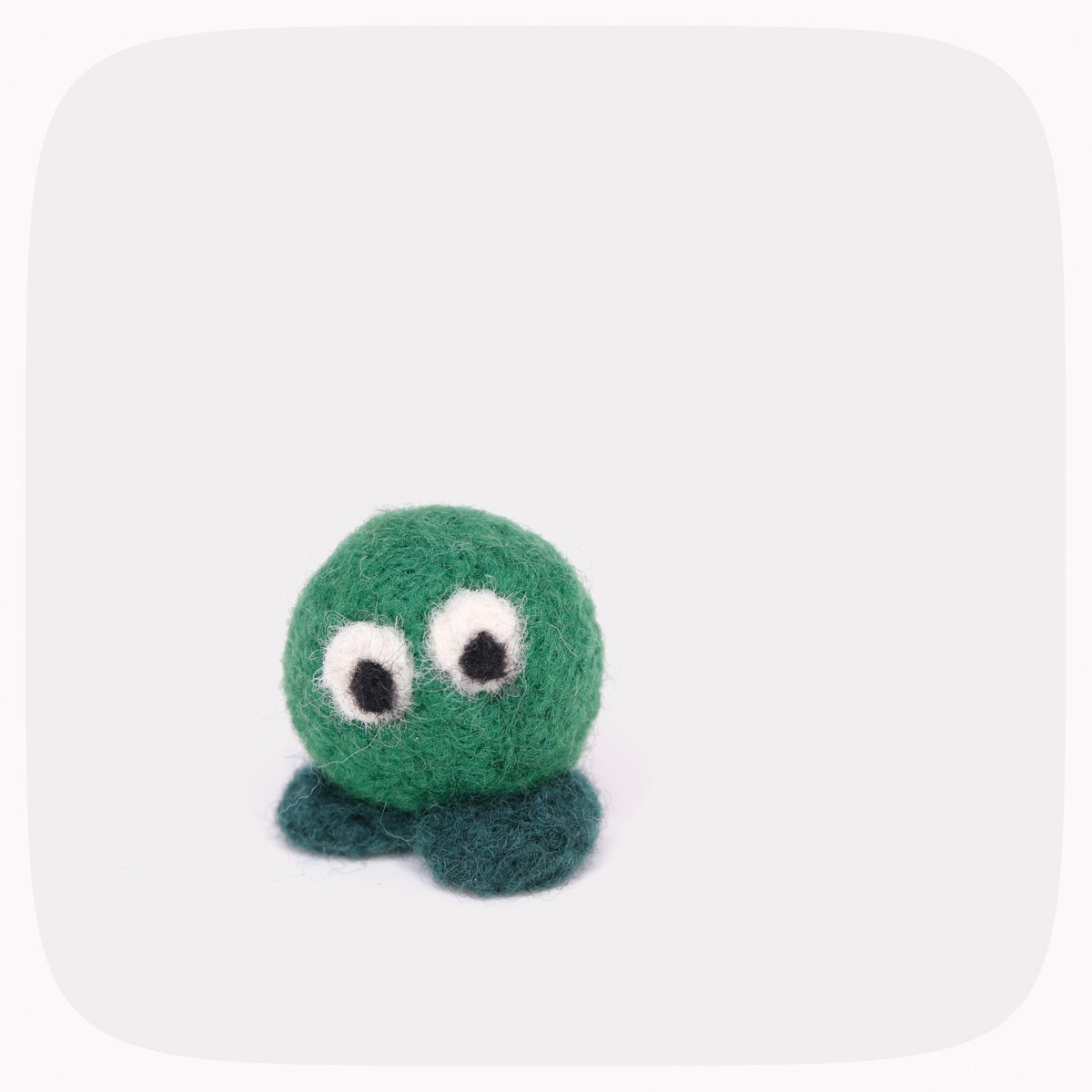 A small felted wool octopus toy in green with dark teal tentacles and large white-and-black googly eyes, centered on a light gray background with rounded corners.