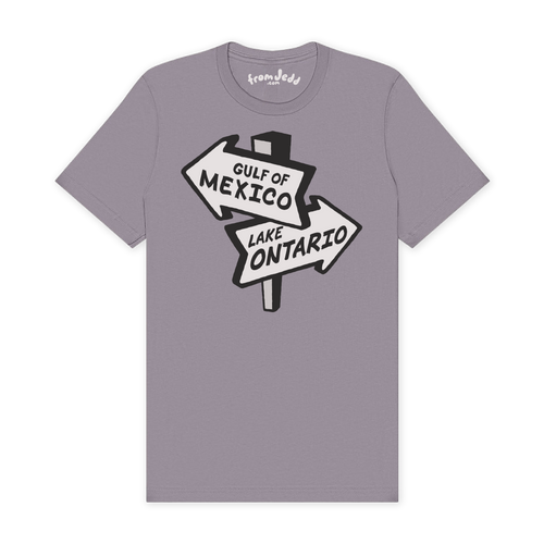 A light purple-gray crewneck t-shirt featuring a graphic of a road sign pointing to 'GULF OF MEXICO' and 'LAKE ONTARIO' in white and black.