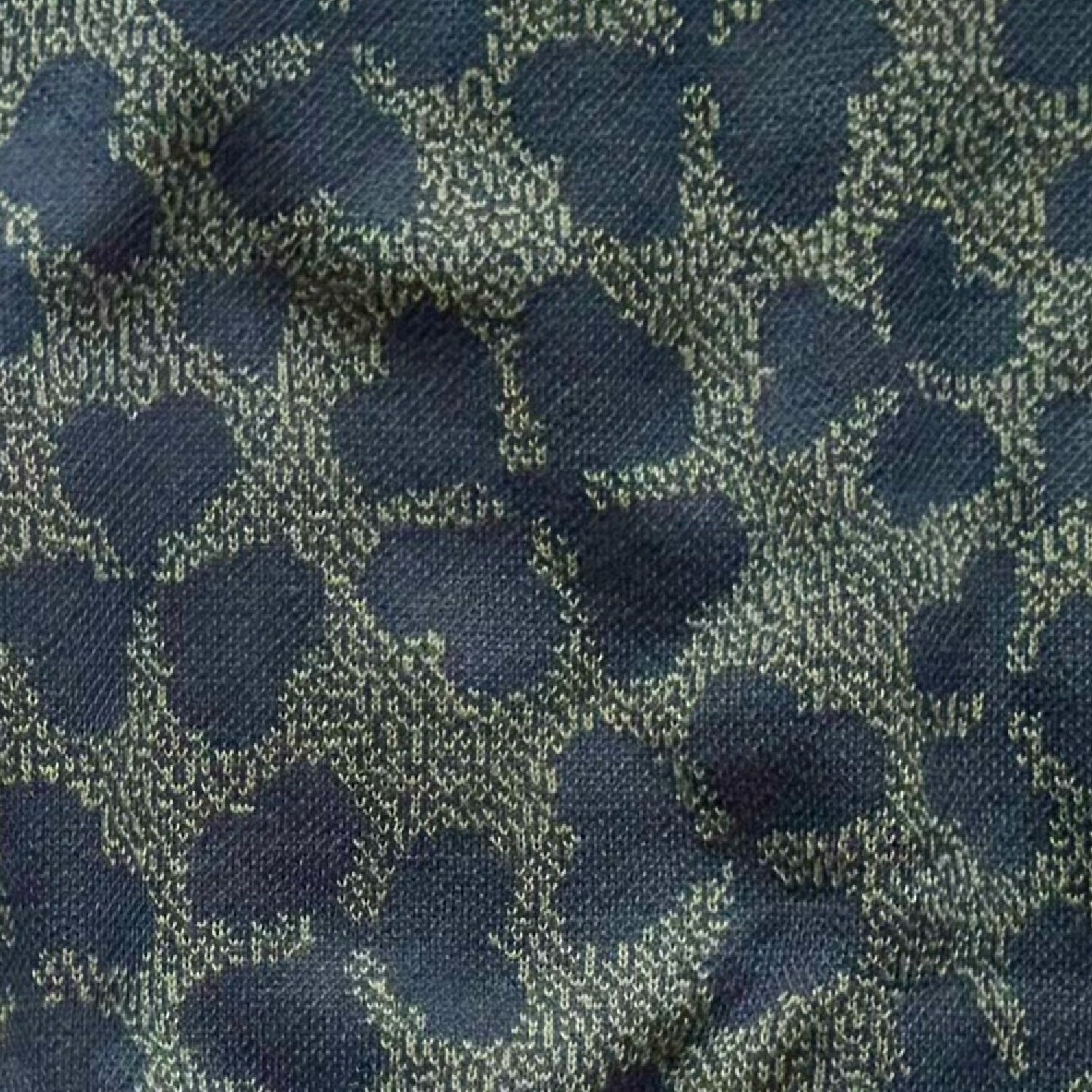 Close-up of the knitted four leaf clover design by Jedd — lucky charm jacquard knitwear detail