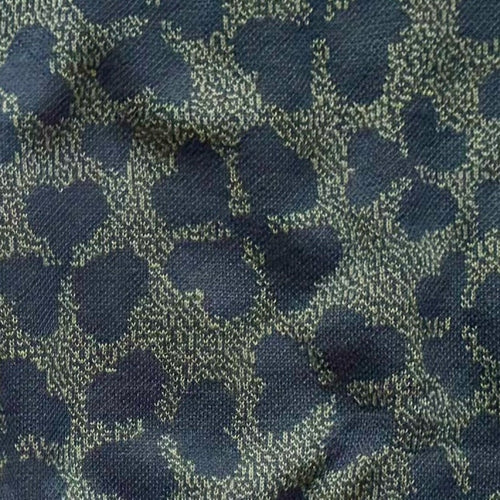 Close-up of the knitted four leaf clover design by Jedd — lucky charm jacquard knitwear detail