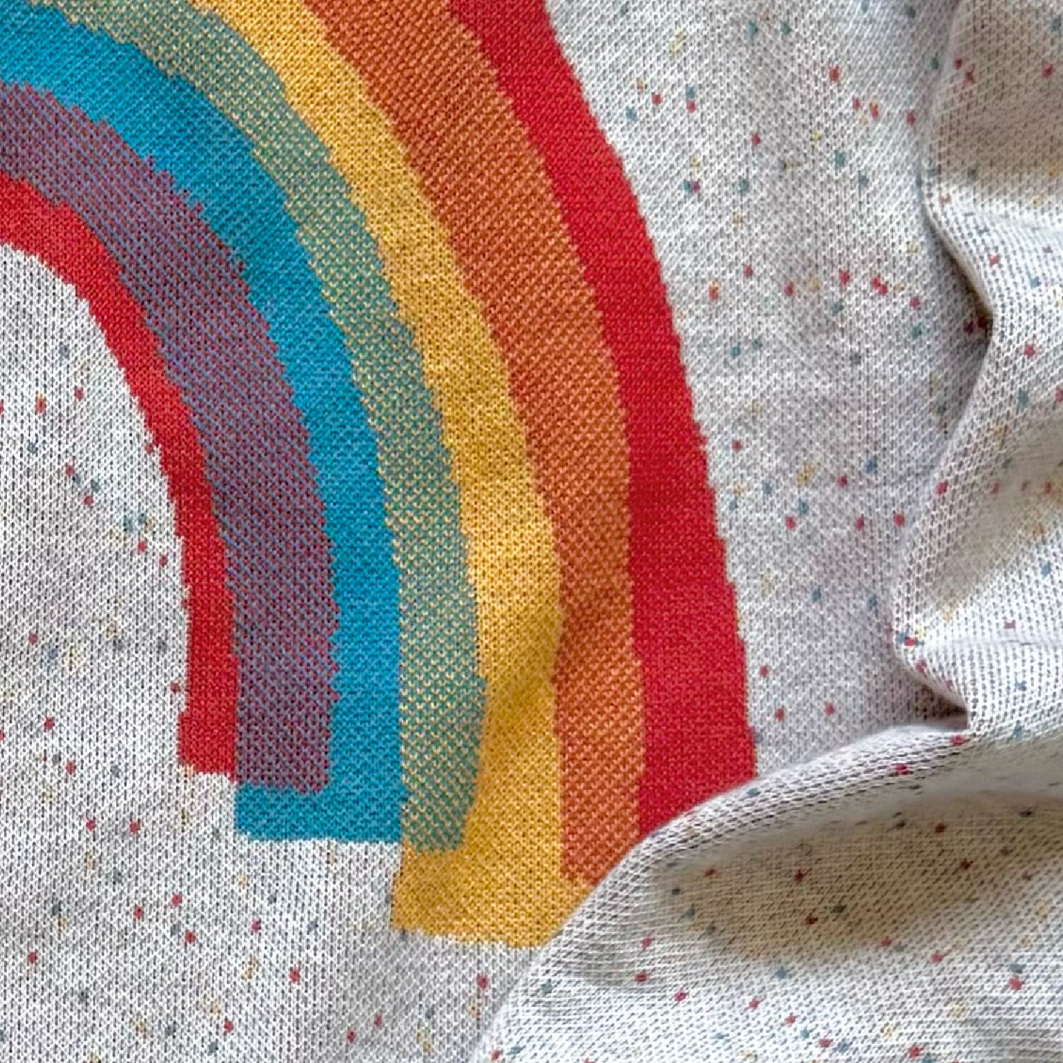 Close-up of the knitted rainbow design on the Over the Rainbow sweater by Jedd — colorful jacquard knitwear detail