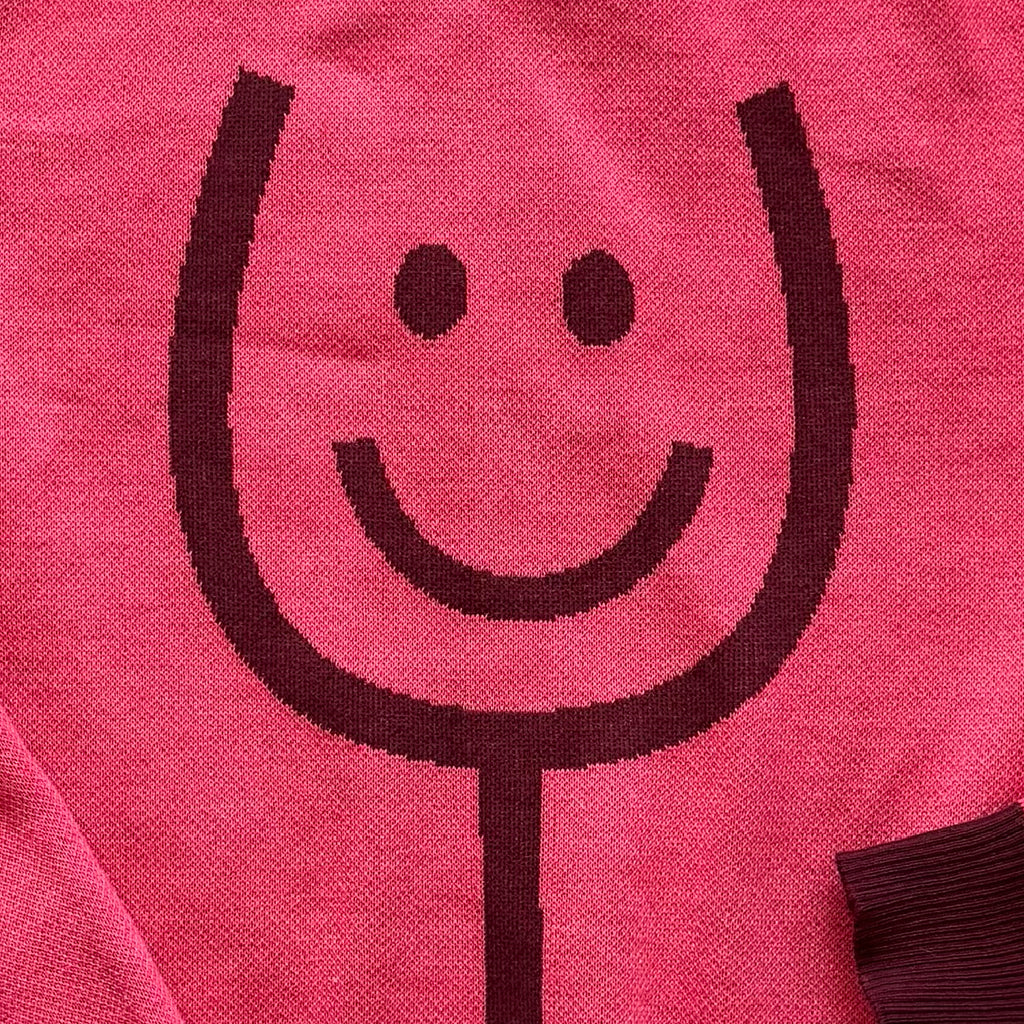 Close-up of the knitted wine glass design on the Happy Wine pink sweater by Jedd — jacquard knitwear detail