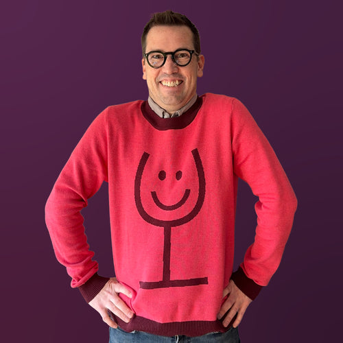 Jedd wearing the Happy Wine pink graphic knit sweater — artist-made designer knitwear for wine lovers