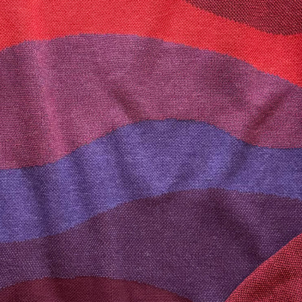 Detail of the knitted horizon layers on the Horizons red sweater by Jedd — jacquard knit texture