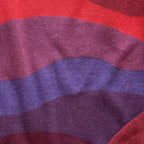 Detail of the knitted horizon layers on the Horizons red sweater by Jedd — jacquard knit texture