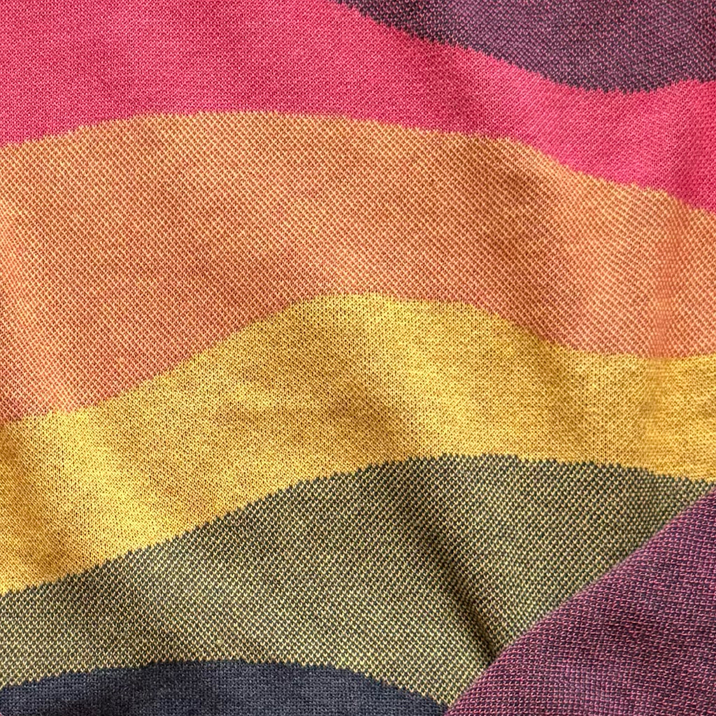 Close-up of the layered colorful horizon knit detail on the Horizons sunset sweater by Jedd