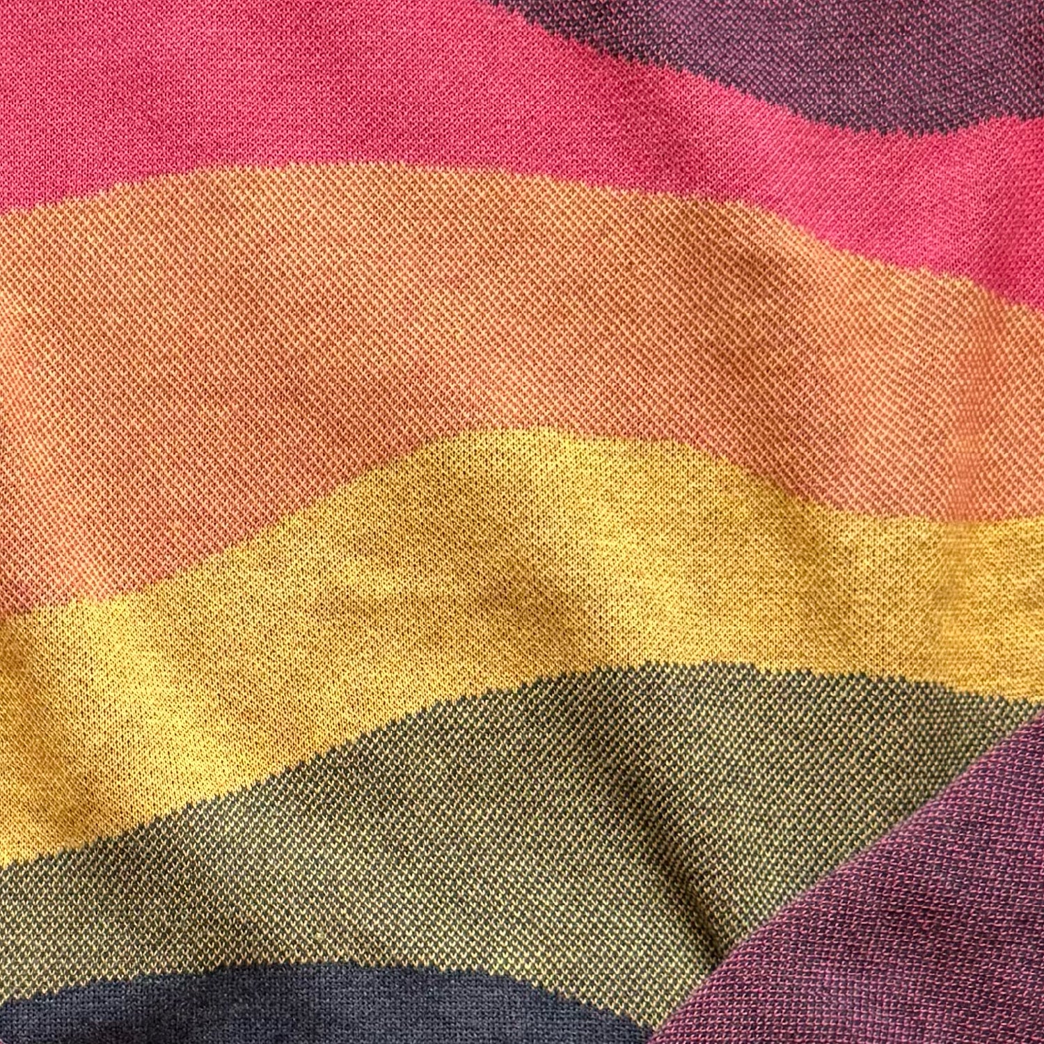 Close-up of the layered colorful horizon knit detail on the Horizons sunset sweater by Jedd