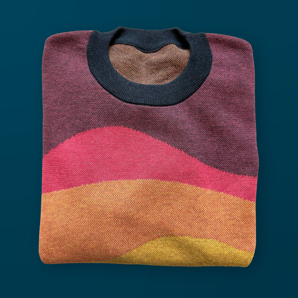 Folded Horizons graphic knit sweater in sunset — cozy layered knit design by artist Jedd