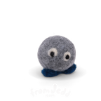 A small felt plush sculpture with a round gray body, white and black eyes, and dark blue feet, photographed on a clean white background.