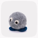 A gray felted ball with eyeballs and blue feet.