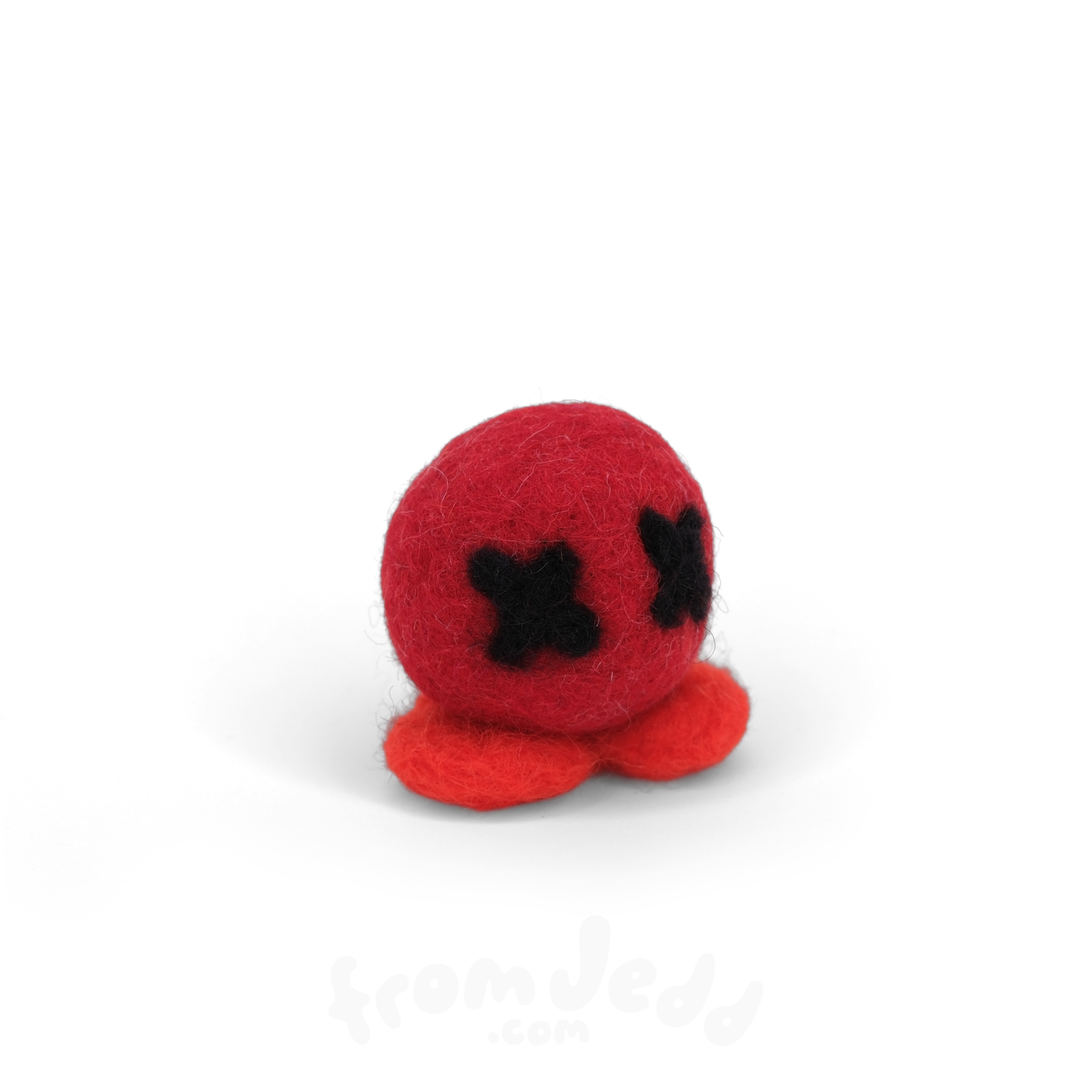 A small red felt octopus toy with black stitched eyes, photographed on a clean white background.