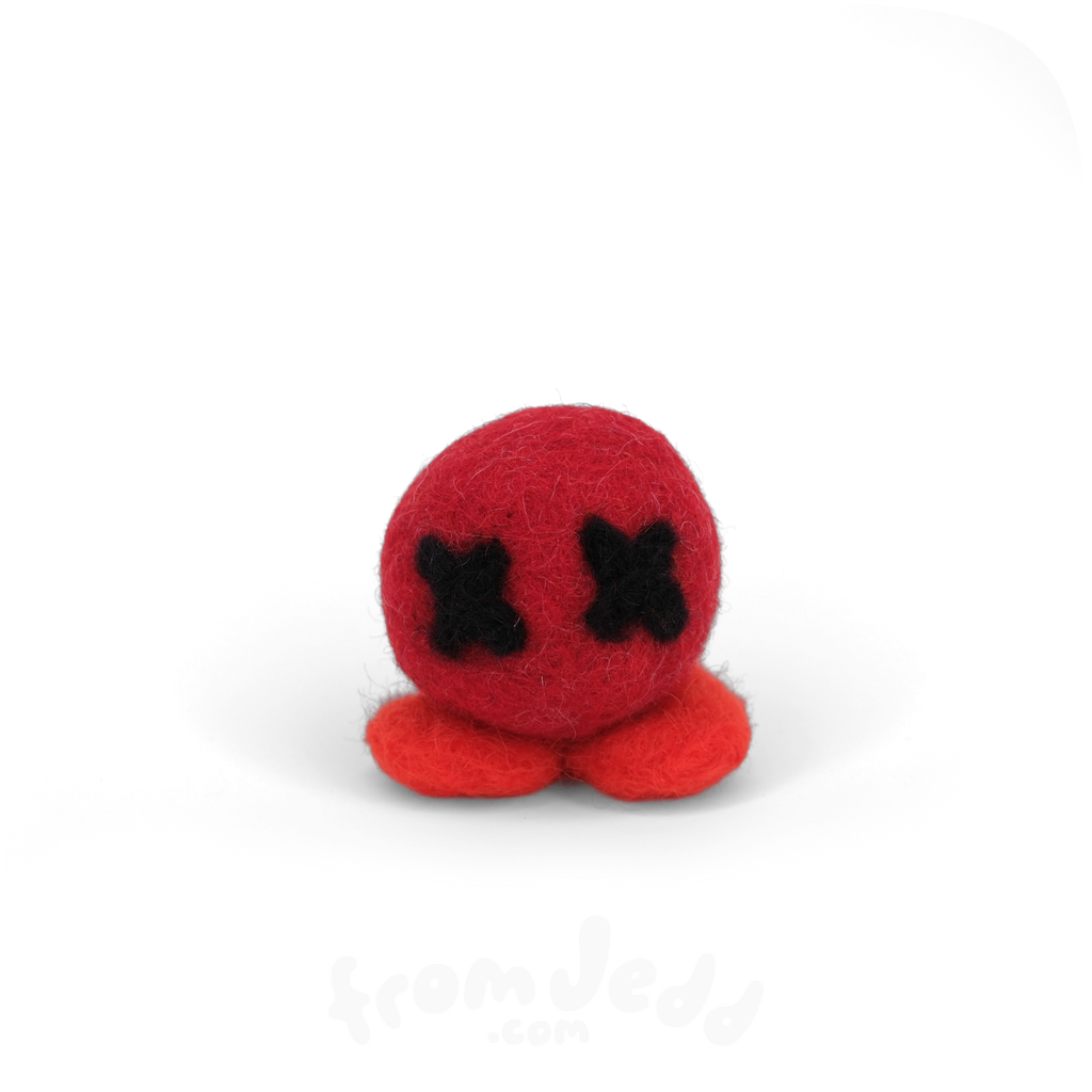 A small red felt plush toy with black stitched X-shaped eyes and two red feet, centered on a plain white background.