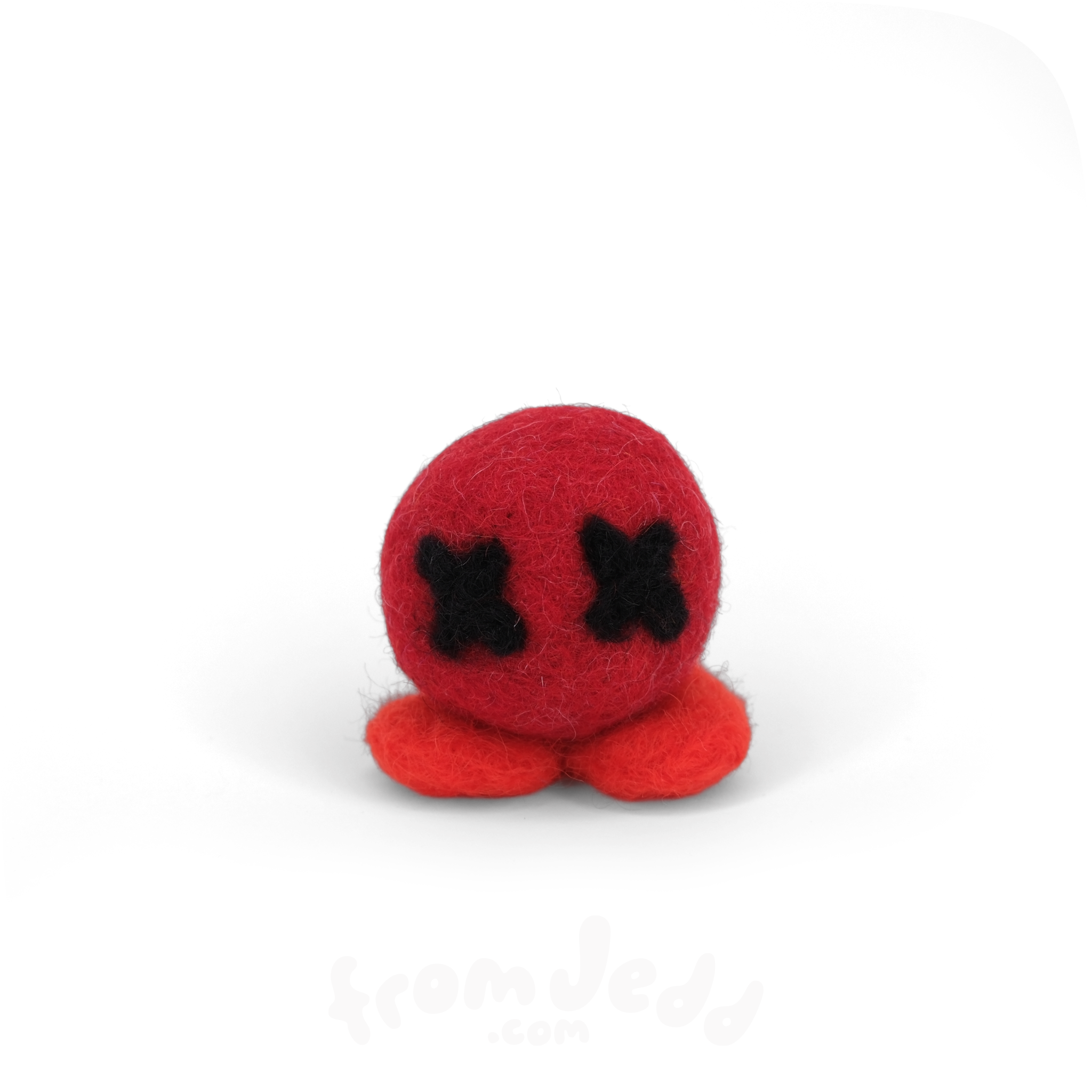 A small red felt plush toy with black stitched X-shaped eyes and two red feet, centered on a plain white background.
